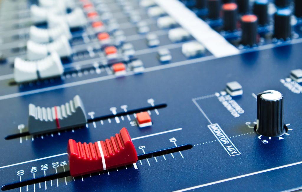 Close-up of mixing console faders